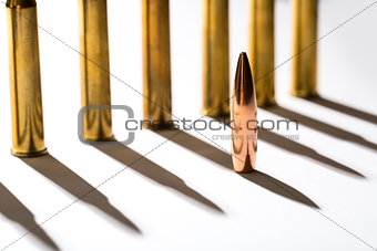 Macro shot of bullet casings on a white studio background
