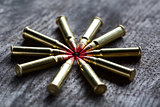Macro shot of small-caliber tracer rounds with a red tip