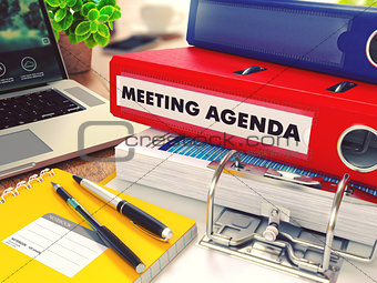 Meeting Agenda on Red Office Folder. Toned Image.