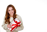 Christmas woman holding present excited.wearing santa hat looking to side showing gift isolated on white background. Beautiful young woman.