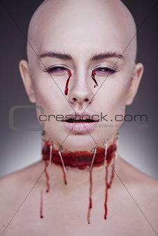 Horrible scary zombie woman. Halloween makeup.