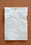 Blank piece paper pinned into corkboard
