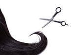 Black shiny hair strand with professional scissors 