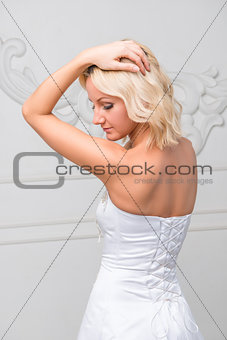 elegant beautiful bride on against a white wall