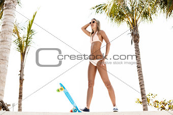 sexy suntanned lady is ready to go on penny board