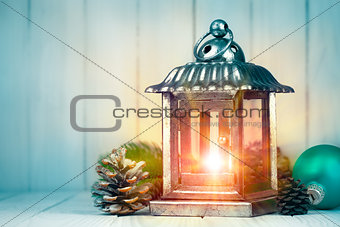 Christmas lamp with pinecone and ball on wooden board