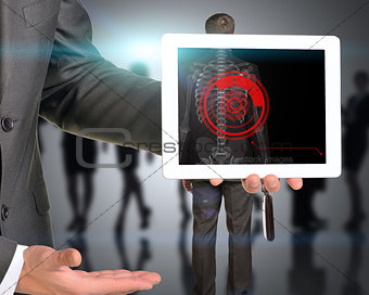 Businessman holding tablet with x-ray of mans back