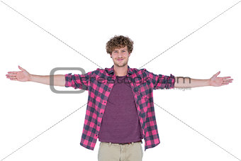 Happy handsome man looking at camera with arms stretched