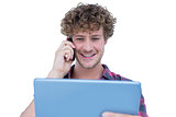 Happy handsome man holding tablet computer and having a phone call