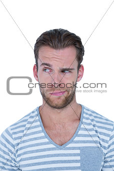 Handsome casual man grimacing in front of camera