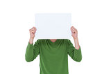 Casual man hiding his head with blank paper