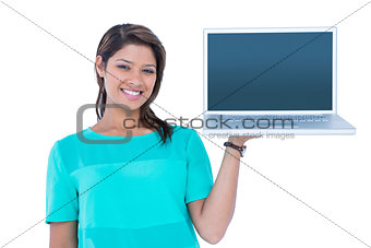 Happy pretty brunette showing laptop computer