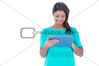 Happy pretty brunette using tablet computer