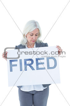 Businesswoman holding sign in front of her