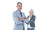 Smiling businesswoman and man with arms crossed