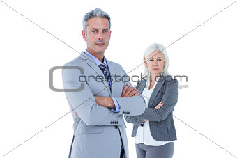 Smiling businesswoman and man with arms crossed