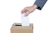Businessman putting ballot in vote box