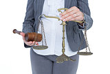 businesswoman holding scales of justice