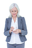 Businesswoman holding smartphone and looking at camera