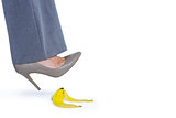 Woman with heel shoes walking on banana