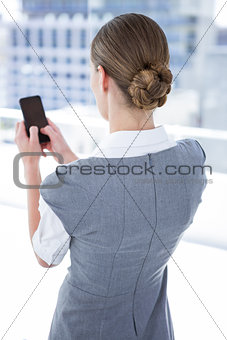 Businesswomen texting with his smartphone