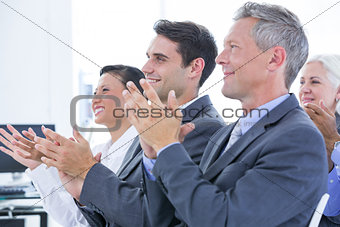 Business team applauding during conference