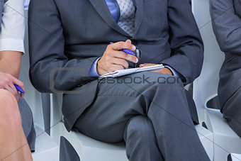 businessman taking a note during a meeting