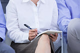 businesswomen taking a note during a meeting