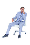 Handsome businessman sitting on a swivel chair