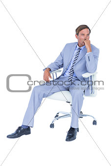 Handsome businessman sitting on a swivel chair