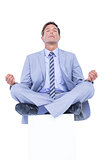Zen businessman meditating in yoga pose