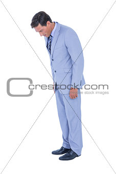 Standing businessman looking at his shoes