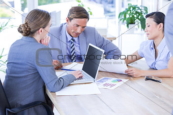 Colleagues with laptop and digital tablet in meeting