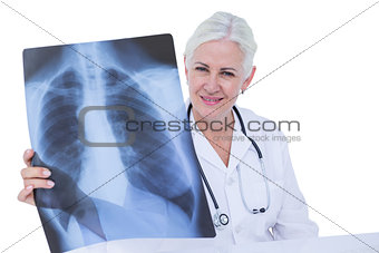 Serious smiling doctor looking at x-ray