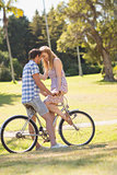Young couple on a bike ride in the park