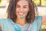 Young woman having fun with powder paint