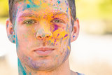 Young man having fun with powder paint