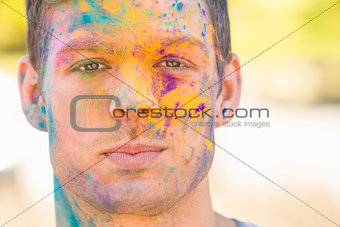 Young man having fun with powder paint