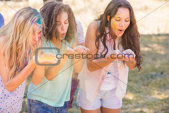 Young women having fun with powder paint