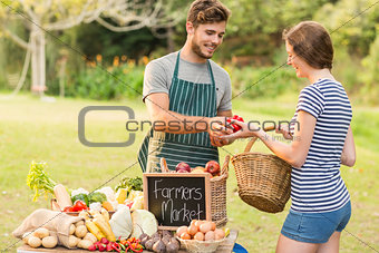 Brunette buying peppers at the farmers market