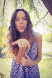 Pretty brunette blowing kiss at camera