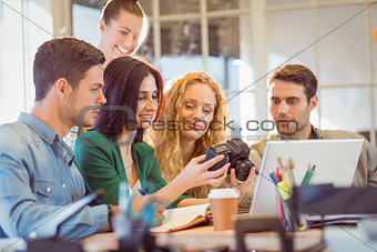 Portrait of smiling casual colleagues using computer