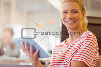 smiling young women using digital tablet