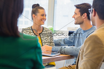 Smiling colleagues talking together