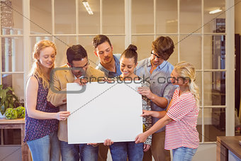 Creative business team holding cardboard written