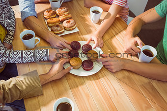 Business people taking cakes on table