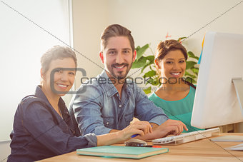 Colleagues using laptop at office