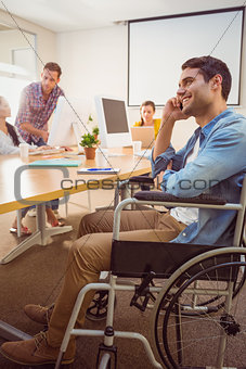 Creative businessman in wheelchair on the phone
