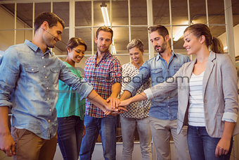 Creative business team putting their hands together