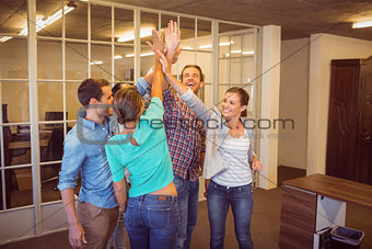 Creative business team raising their hands